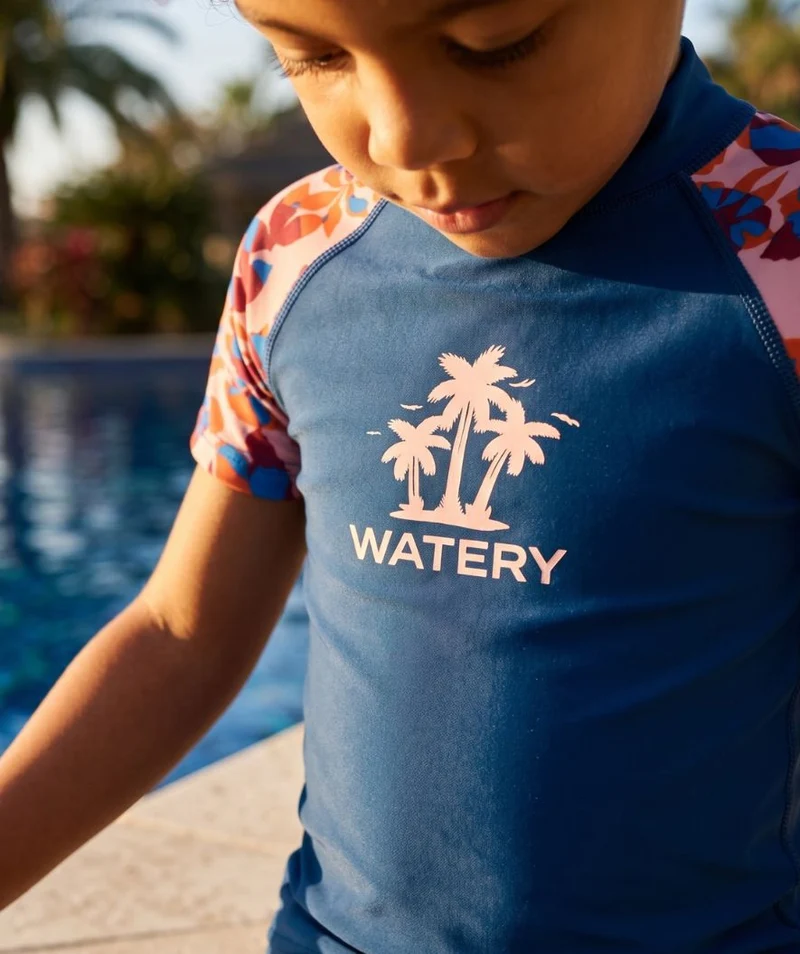 Watery UV Shirt für Kinder - Osiris Kurzarm Rashguard - Hellrosa/Dunkelblau